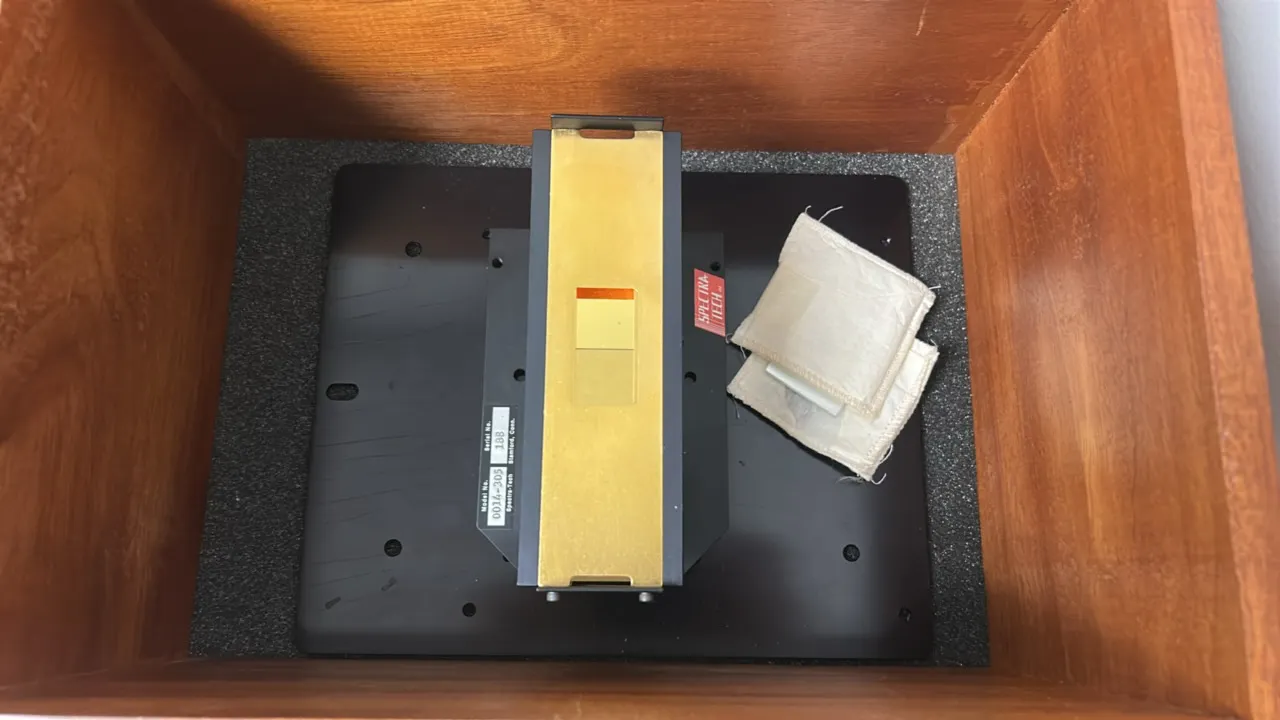 Spectra-Tech FT80 specular reflectance accessory, model 0014-305. Features optical sample assembly on a mounting base plate and includes a fitted wood