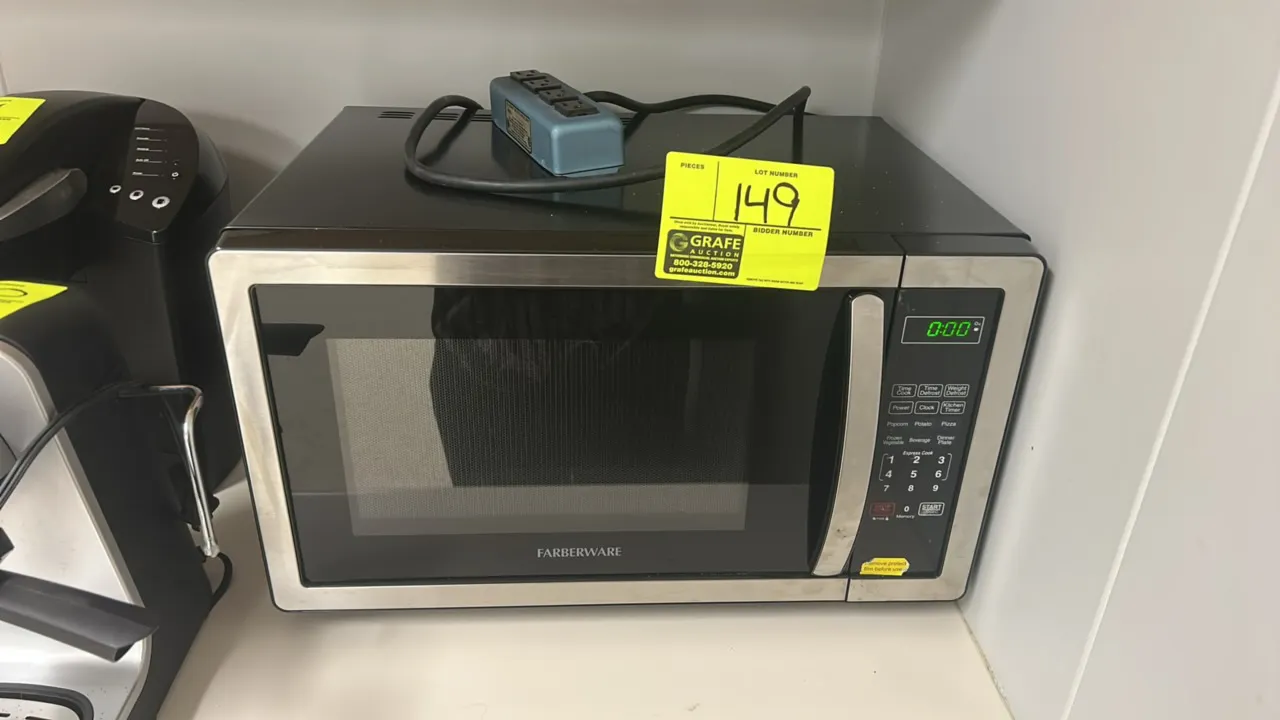 Farberware countertop microwave oven. Features stainless steel trim, digital control panel with LED display, glass turntable, and express cooking pres