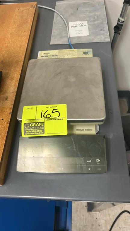 Mettler Toledo PR Series precision balance. Features a stainless steel weighing platform, digital display terminal, built-in leveling bubble, and adju