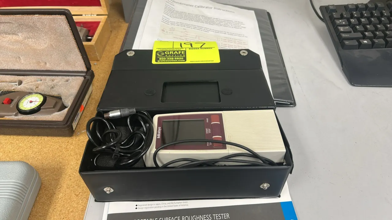 Mitutoyo Surftest SJ-210 portable surface roughness tester. Features digital color LCD screen and push-button controls. Includes connecting cable, ref