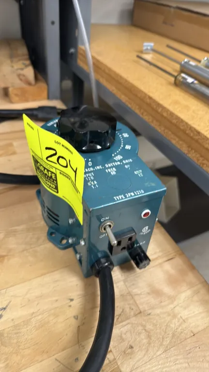 Staco 3PN1210 variable autotransformer. Features 0-100 rotary dial control, toggle power switch, indicator light, standard 3-prong receptacle, and 15A