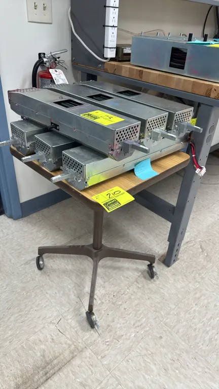 Portable utility table. Features a laminated wood top with protective edge trim. Dimensions: 20" x 20". Mounted on a brown metal pedestal with a 4-sta