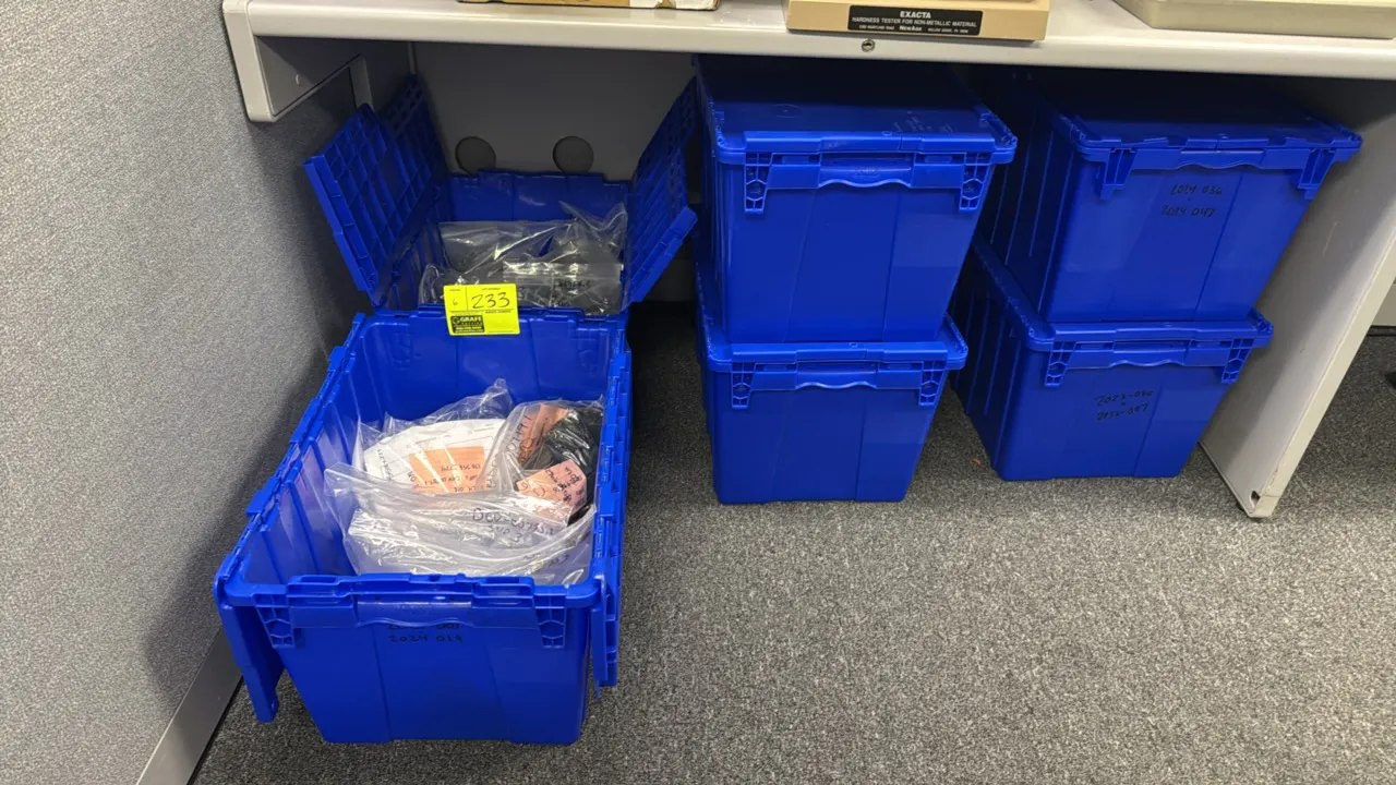 Blue plastic storage totes with various sample materials. Features attached hinged split lids and molded side handles. Includes assorted bagged sample