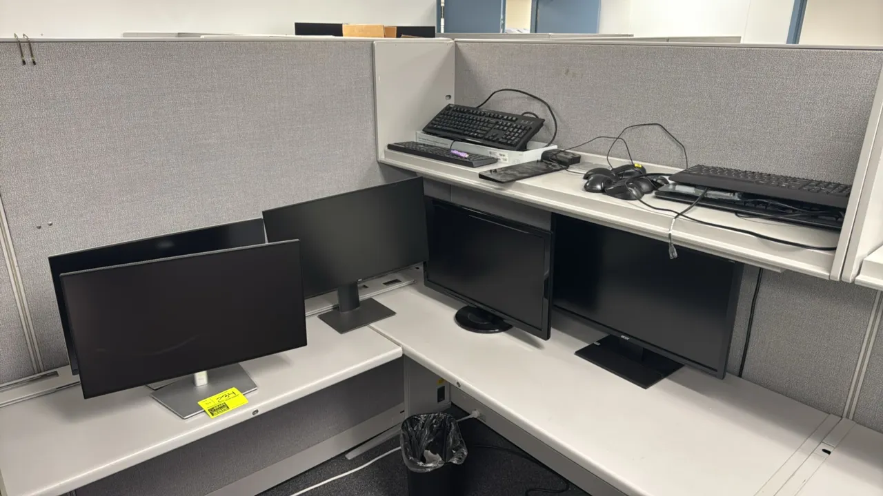Dell, ViewSonic, and Acer 24" computer monitors. Includes assorted computer keyboards, mice, and an HP docking station. Cubicle and desk not included.