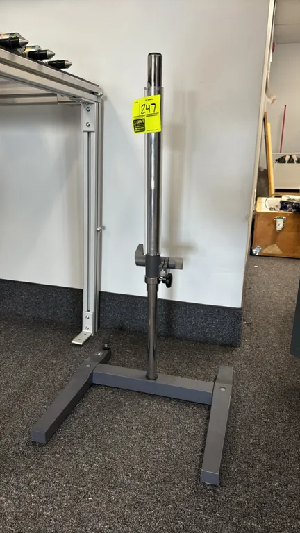 Metal adjustable height stand. Features chrome upright column with adjustable locking clamp collar. Mounted on a gray metal base. 18" x 17".