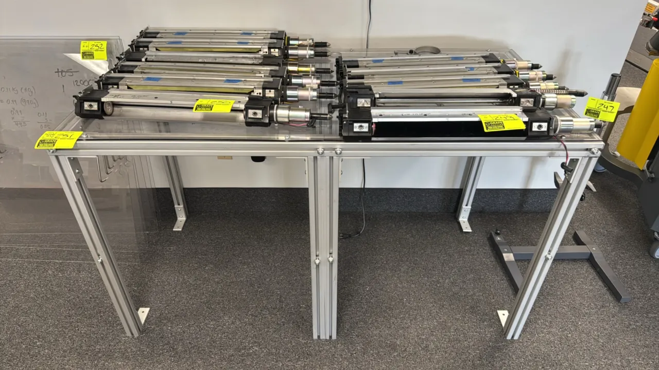 Modular aluminum lab table with clear polycarbonate top. Constructed with extruded aluminum framing. Includes additional aluminum framing sections and