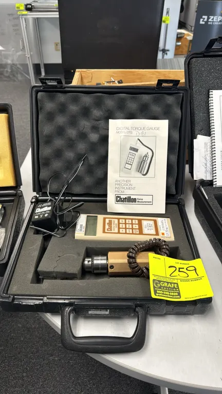 Chatillon DTG-3 digital torque gauge. Features handheld digital display, remote chuck torque sensor attachment with coiled cord, and AC power adapter.
