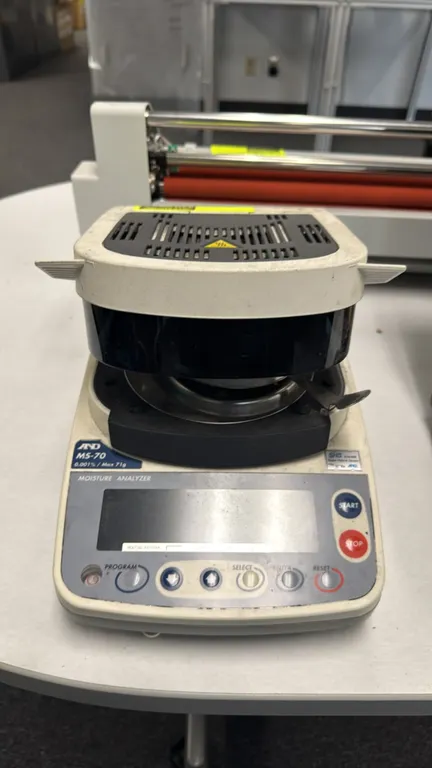 A&D MS-70 moisture analyzer. Features 71g maximum capacity, 0.001% moisture resolution, digital display, sample pan assembly, and RS-232C interface. E