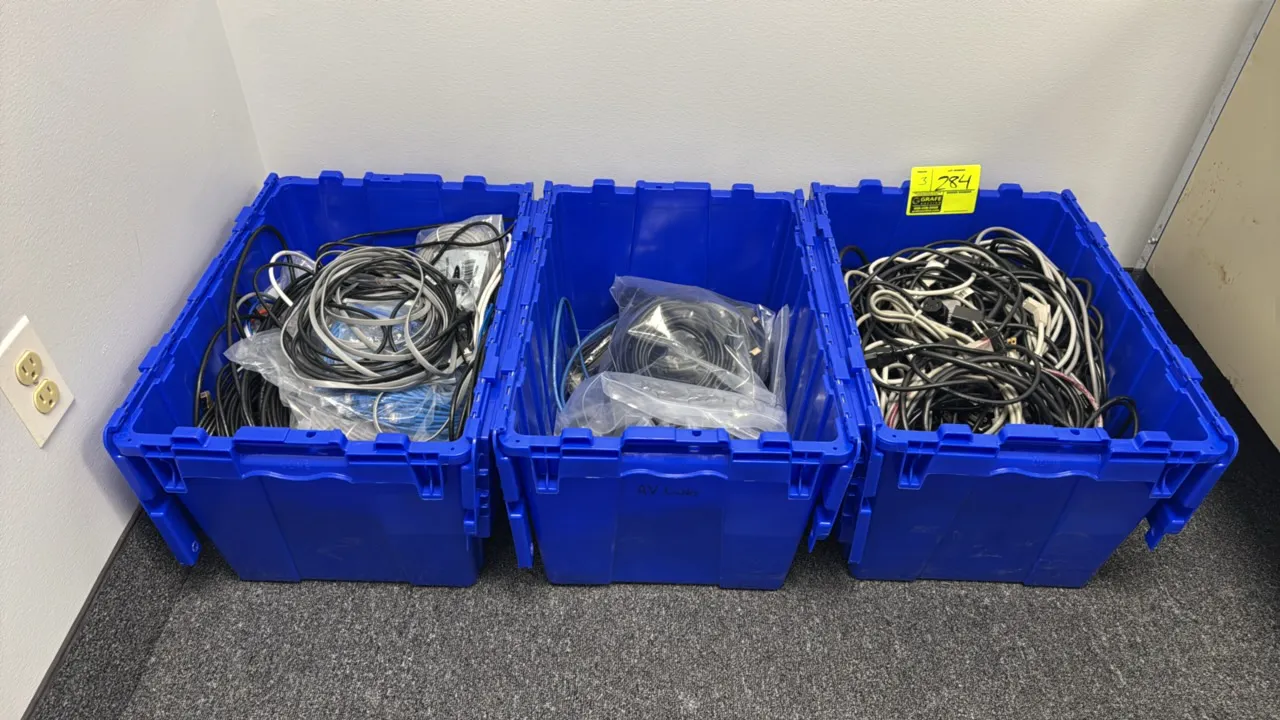 Blue plastic tote bins with assorted electrical cords and cables. Includes Ethernet network patch cables, AV and HDMI cables, and computer power cords
