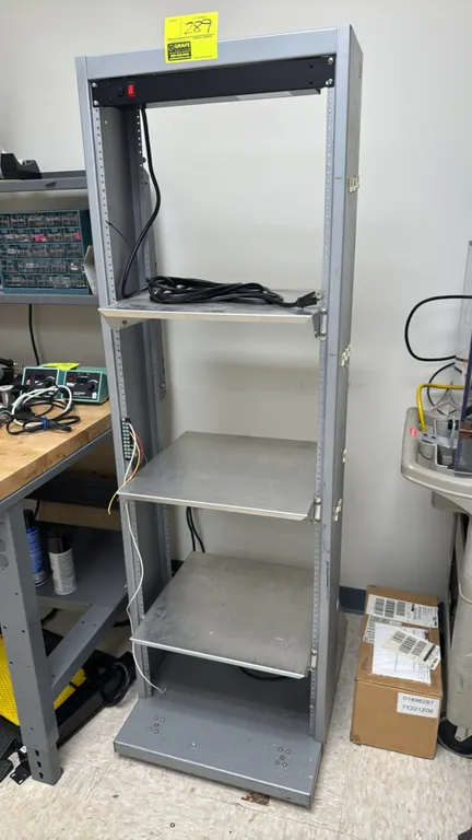 Metal IT equipment rack. Features (3) adjustable metal shelves, integrated rackmount power strip with switch and power cord, and side terminal strip.