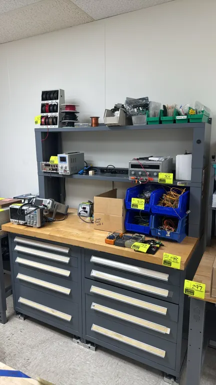 Metal laboratory workstation. Features wood top, 10-drawer under-cabinet base with drawer contents, and (2) overshelves. Dimensions: 5' x 3'. Note: Ta