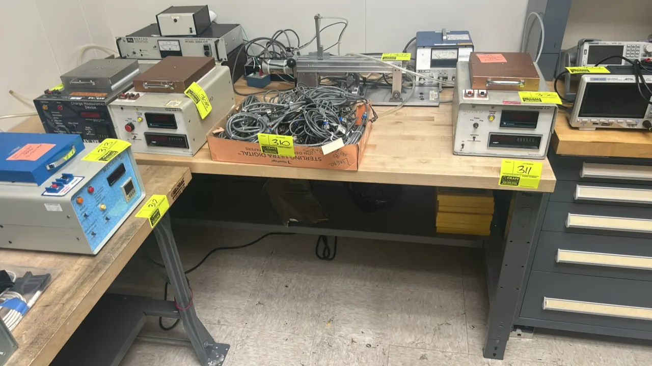Wooden top workbench with metal base. Features butcher block work surface and lower steel shelf. 6'L x 3'W. Contents and equipment not included.