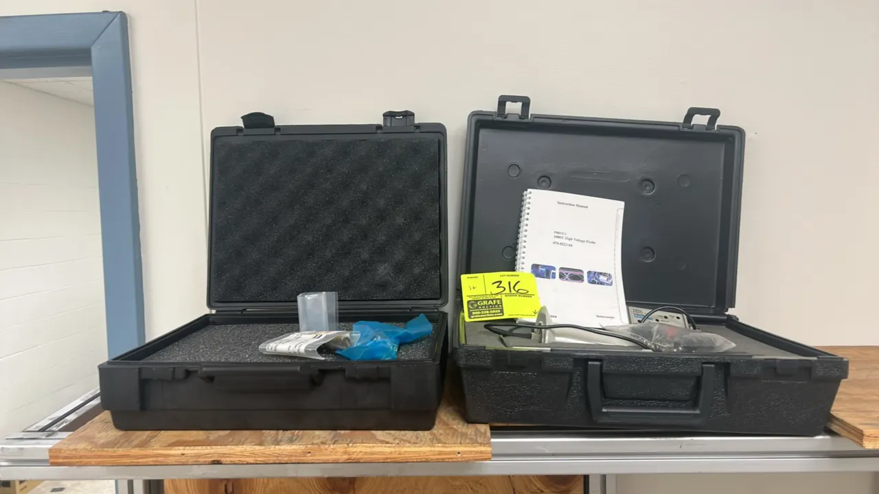 Tektronix P6015A 1000X high voltage probe. Includes probe body assembly, compensation box, instruction manual, assorted accessories, and two hard carr