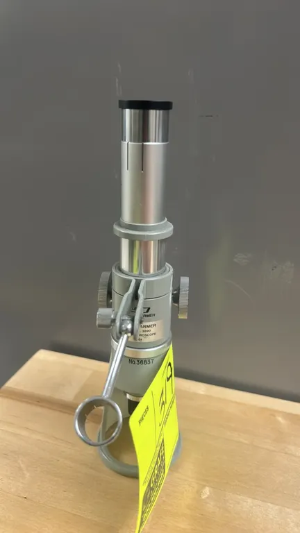Cole-Parmer 3890 shop microscope. Features 60x magnification, WF10X eyepiece, dual focusing knobs, adjustable light bracket, and horseshoe base. S/N: