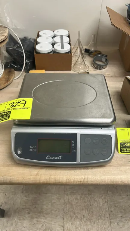 Escali M-Series digital multifunctional scale. Features stainless steel weighing platform, digital LCD display, front leveling bubble, and push-button