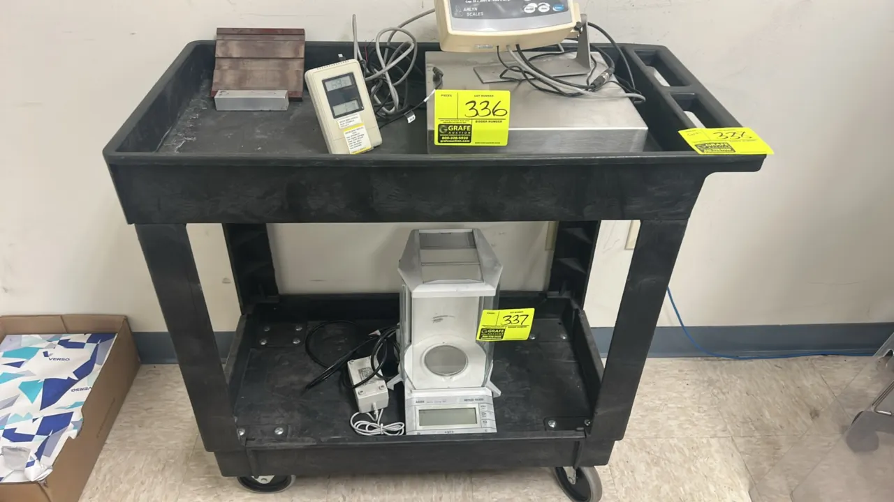 Poly 2-tier utility service cart. Features molded polyethylene construction, deep-lipped shelves, integrated push handle with storage compartments, an