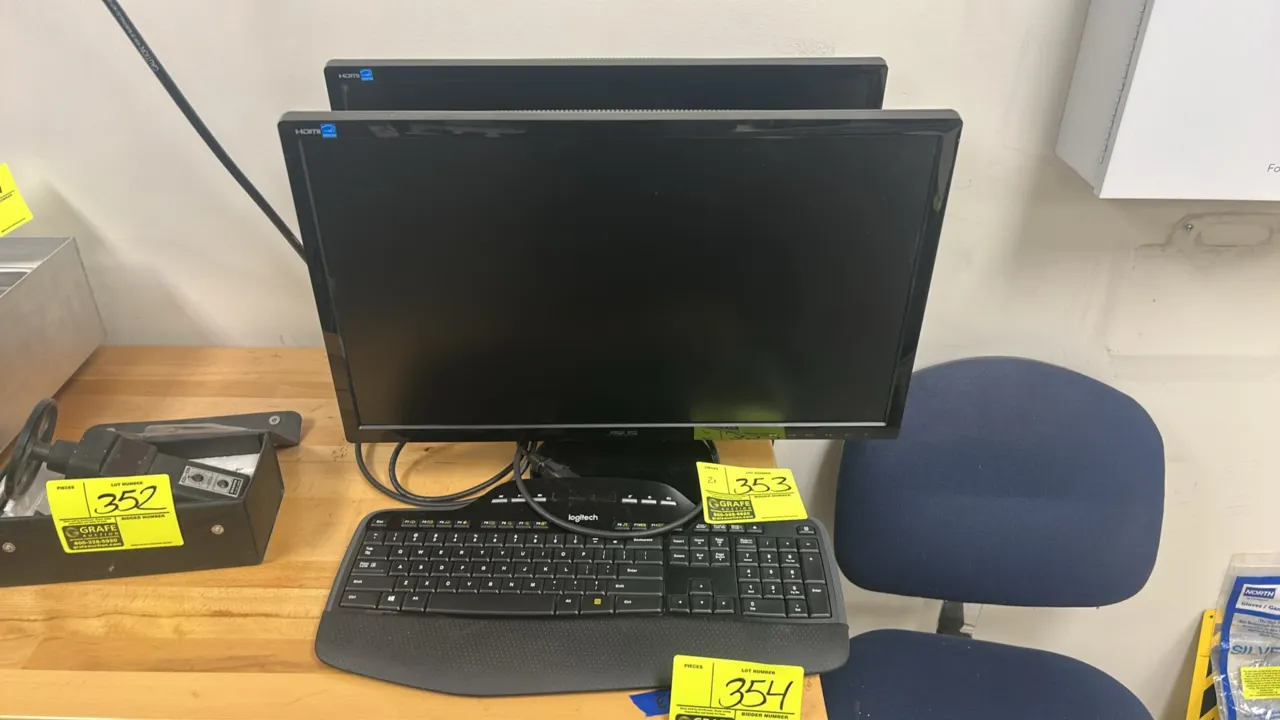 ASUS 24" computer monitors. Features HDMI connectivity and integrated desktop stands. Includes a Logitech keyboard and power cables.