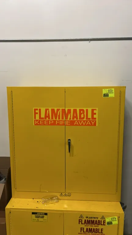 Justrite steel flammable storage cabinet. Features 2-door construction with latch handle, side ventilation, and yellow safety finish. 42" x 12". Lower