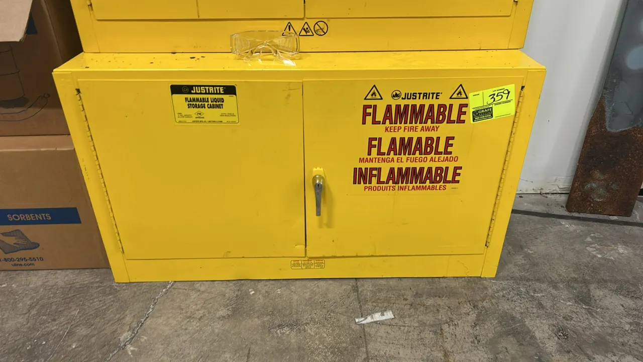 Justrite steel flammable storage cabinet. Features 2-door construction, locking latch handle, side vent connection, and yellow finish. 42" x 18". Uppe