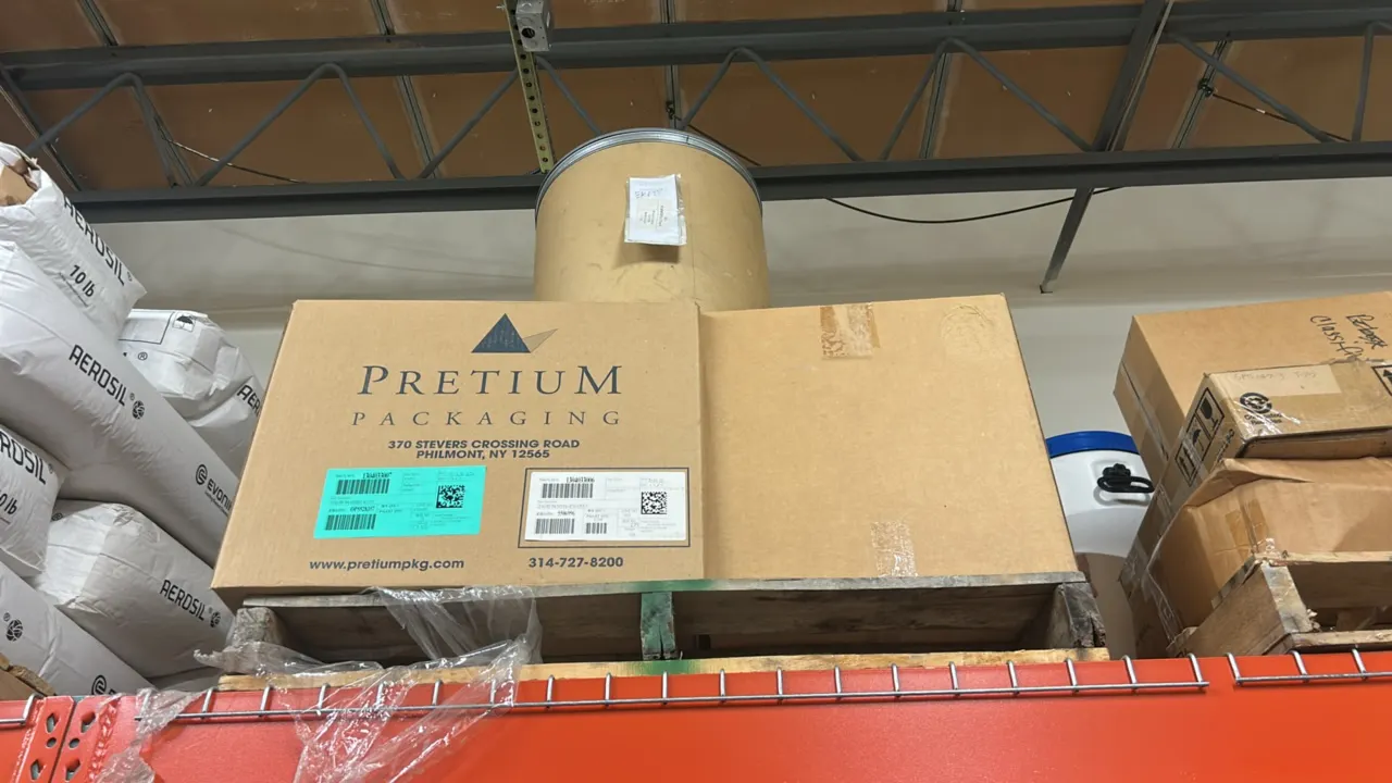 Assorted industrial chemical powders and remaining pallet contents. Includes Evonik AEROSIL fumed silica and AEROXIDE bagged powders, a fiber drum, an