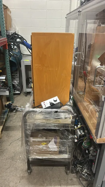 Metal utility cart with contents. Includes a quantity of Kodak NexPress imaging cylinders, Minarik speed control unit, wooden storage cabinet, and ass