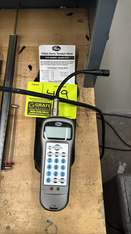 Gates 505C sonic tension meter. Features digital LCD display, flexible corded sensor probe, and belt unit weight reference card. Includes soft storage