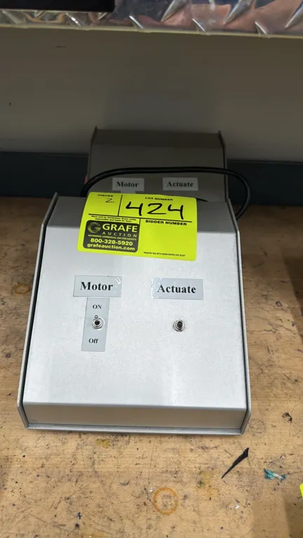 EAS-0008634 Rev A actuator motor controllers. Features sloped metal enclosures, front-panel motor on/off toggle switches, actuate controls, side rocke