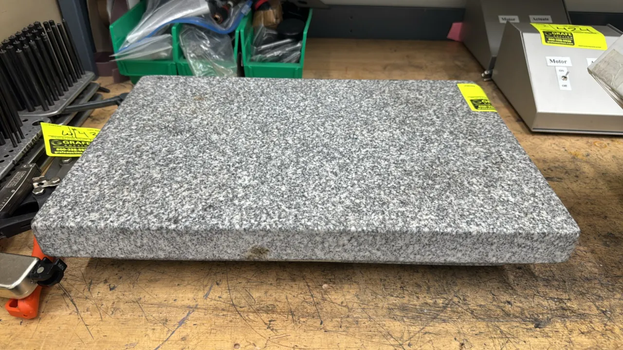 Rahn granite scale stone surface plate. Features solid gray granite construction with side ledges. Dimensions: 18" x 12".