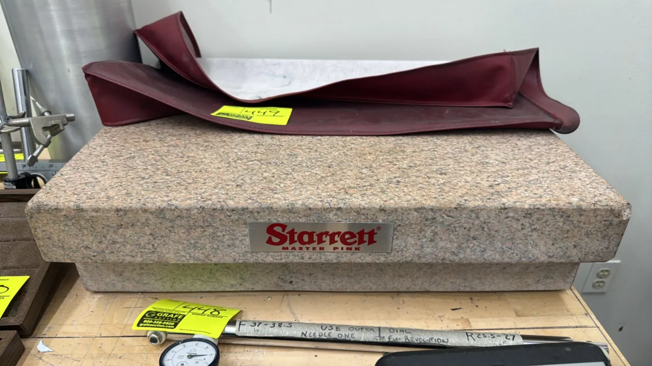 Starrett Master Pink Grade AA laboratory granite surface plate. Features clamping ledges and includes protective vinyl cover. 24" x 18" x 6 1/2".