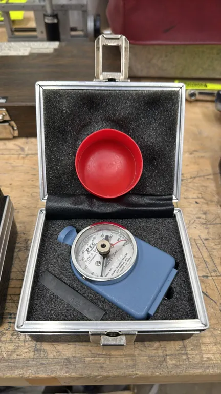 PTC Instruments 306L Type A durometer. Features a 0 to 100 dial scale and ASTM D2240 compliance. S/N: 15255. Includes fitted hard carrying case, prote