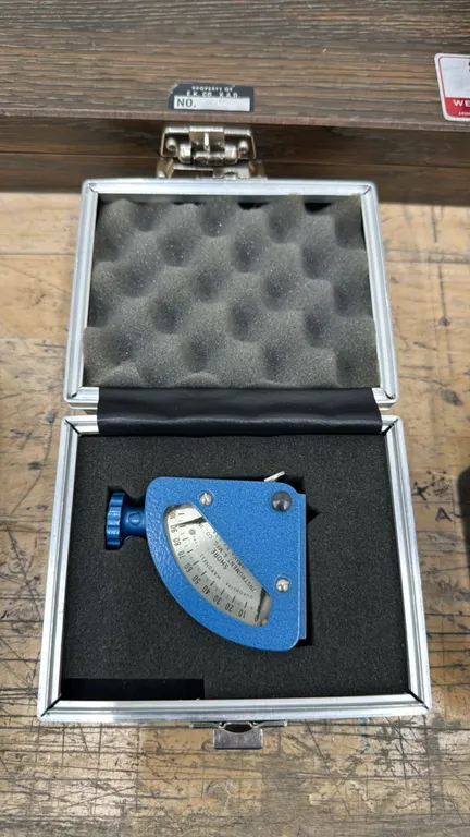 Shore Instrument & Mfg. Co. durometer hardness tester. Features a 0 to 100 hardness scale and blue hammertone finish. Includes fitted latching case wi