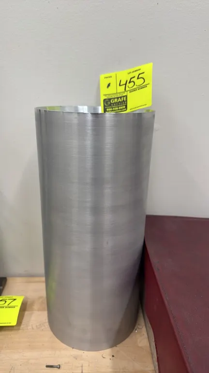 Aluminum cylinder. Features a hollow cylindrical design with a machined finish. 7" x 15".