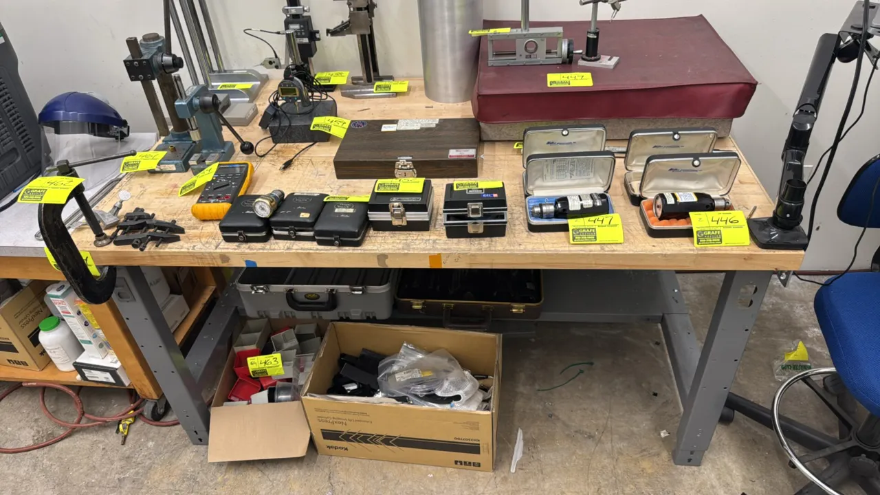Uline industrial workbench. Features a solid wood butcher block top, painted steel frame, lower metal undershelf, and adjustable-height legs with elec