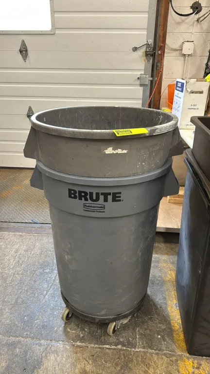 Rubbermaid Brute polyethylene trash cans. Includes (2) stacked round utility containers and (1) caster dolly base. Features integrated side handles. M