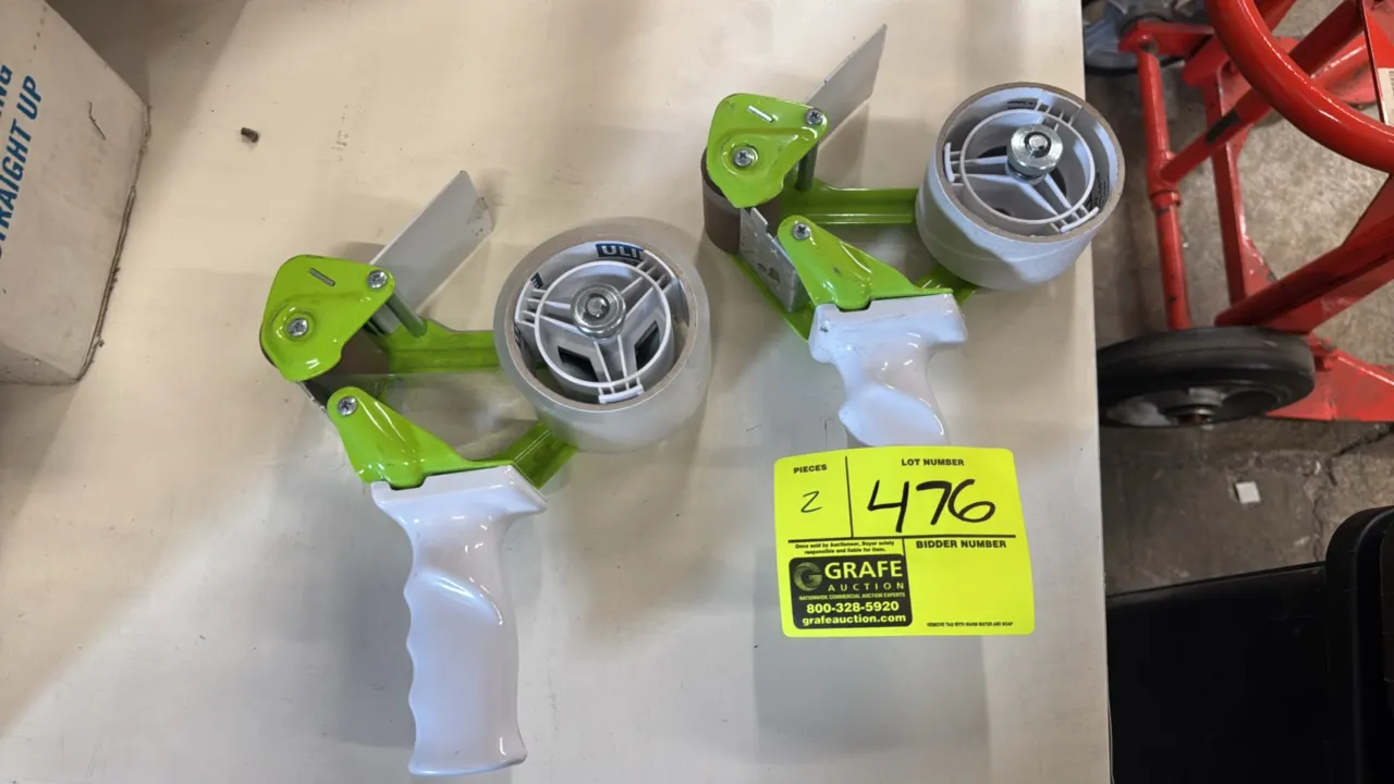 Packaging tape dispensers. Features green steel frame construction, contoured white plastic pistol-grip handle, adjustable tension knob, and serrated