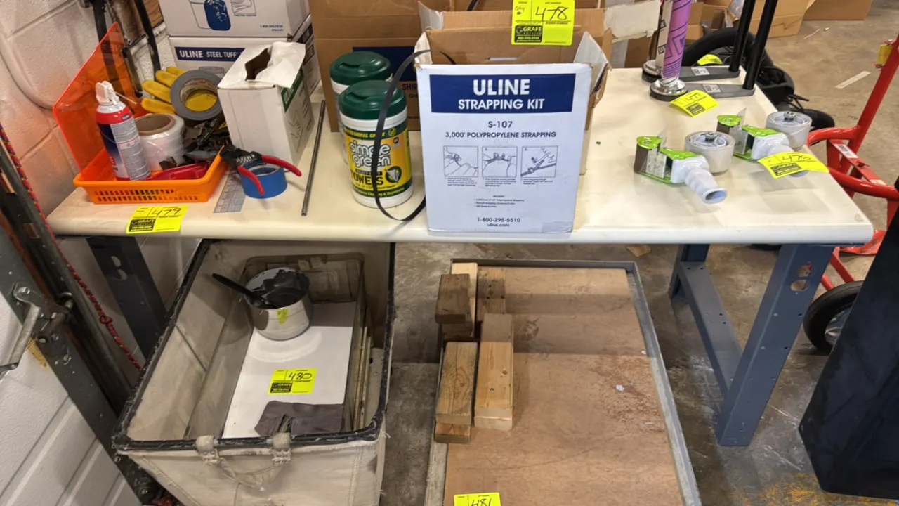 Industrial metal work table. Features a wood laminate top with rounded front edge and painted steel legs with lower support brace. 60" x 30". Contents