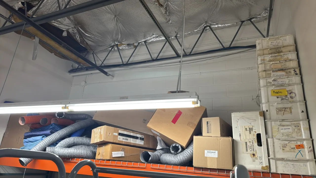 Package lot of warehouse supplies and top-row racking contents. Includes a stack of poly storage tubs, assorted flexible ventilation hoses, padded mov