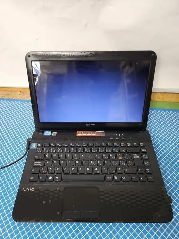 Locked Sony VAIO laptop with AC adapter
