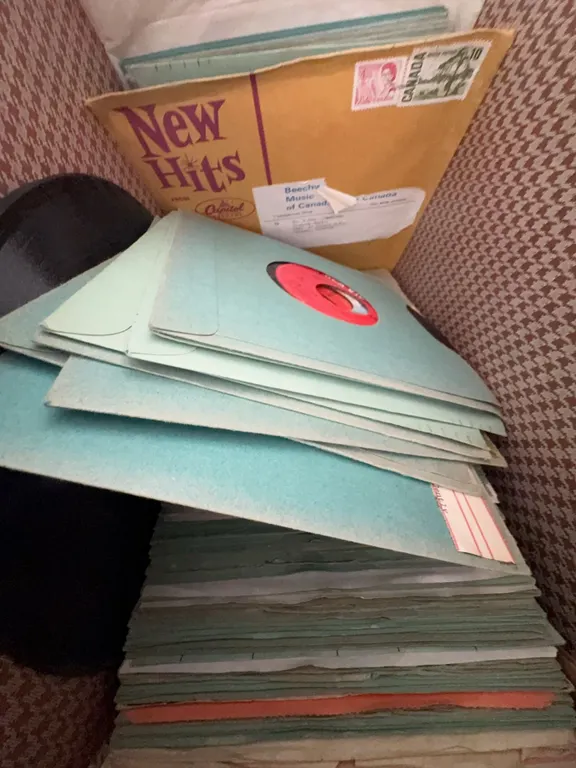 45 RPM Records With Sleeves in Brown Carrying Case