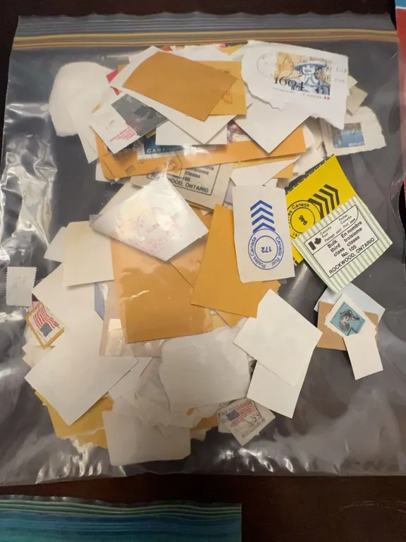Postage Stamps on Paper in Plastic Bag