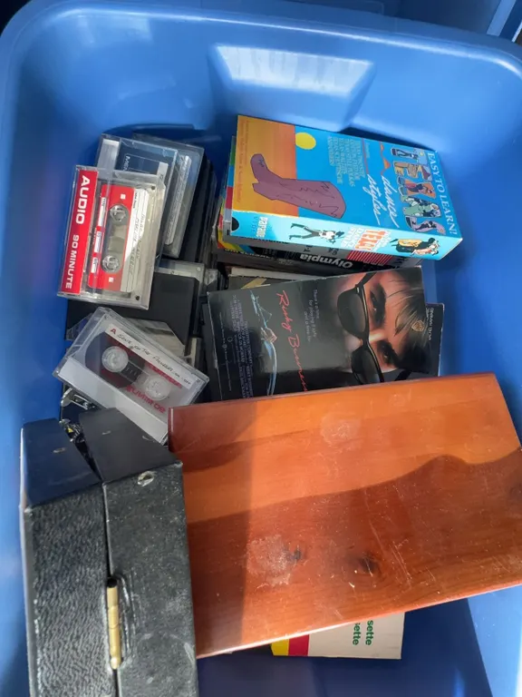 Bin of VHS Tapes, Audiocassette Tapes, and Trinkets