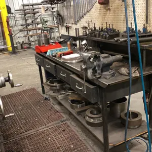 8' LONG METAL WORK BENCH WITH 5" VISE. 4' OVERHEAD LIGHT. PEG BOARD BACK