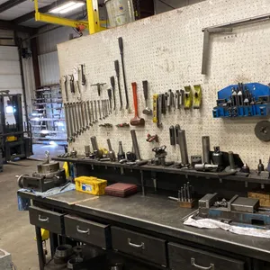 8' METAL WORK BENCH. 4 DRAWERS. PEG BOARD BACK. INCLUDES COMBINATION WRENCH SET. HAMMERS, PRY BARS