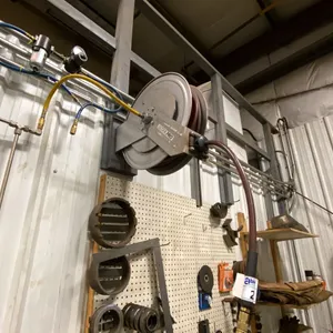 RETRACTABLE AIR HOSE REEL- APPROX 50'. BUYER TO REMOVE FROM WALL