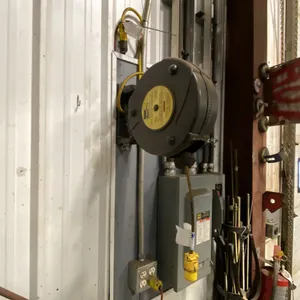 RETRACTABLE EXTENSION CORD-APPROX 50'. BUYER TO REMOVE FROM WALL