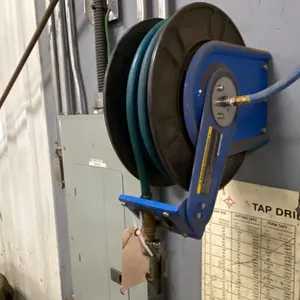 50' AIR HOSE REEL. BUYER TO REMOVE FROM WALL.