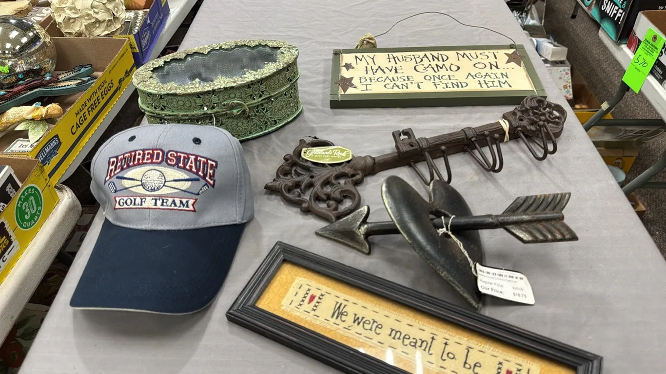 cap, wrought iron hangers, signs, tin box