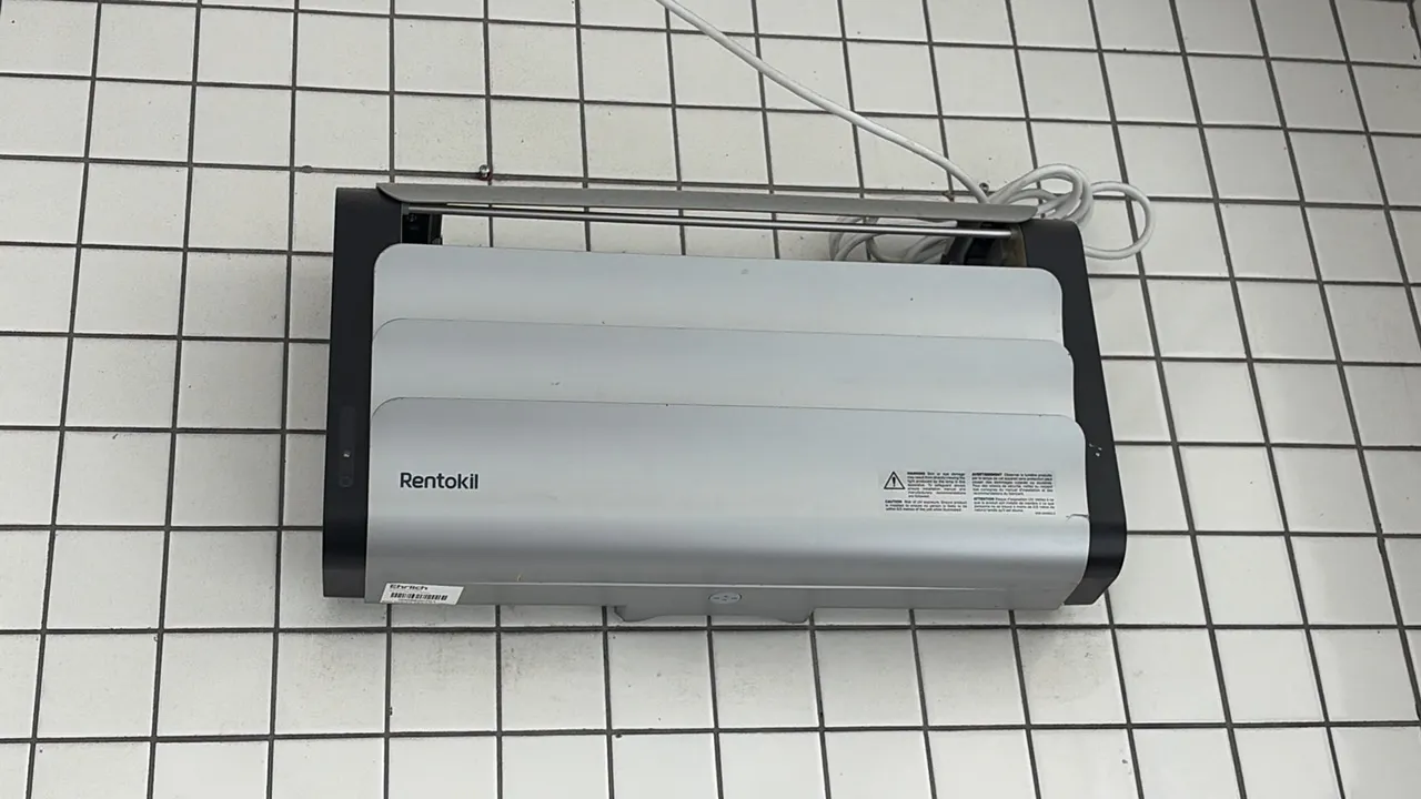 Rentokil insect light trap. Features wall-mount design with silver-tone and black housing. Includes attached power cord.