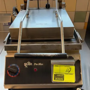 Star Pro-Max sandwich press. Features smooth flat upper and lower platens, counterbalanced top hinge mechanism, analog temperature control dial, and s