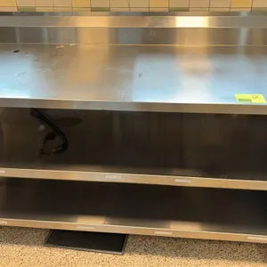Stainless steel work table. Features an integrated backsplash and double undershelf. 72" x 32". Mounted on casters.